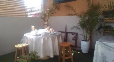 a table with a white table cloth and two stools at Bellavista in Lima