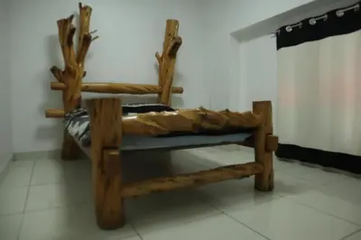 a chair made out of logs sitting in a room at Bellavista in Lima