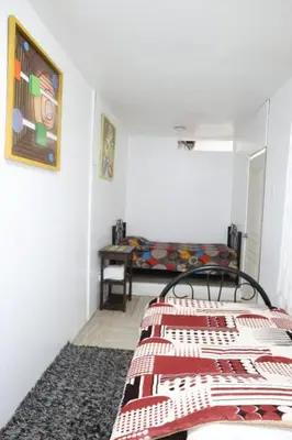 a bedroom with two beds in a room with a table at Bellavista in Lima
