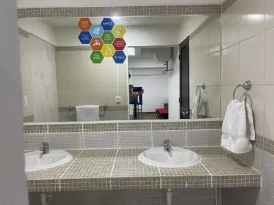 a bathroom with two sinks and a large mirror at Departamentos Alcanfores 775 Miraflores in Lima