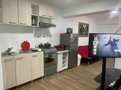 a kitchen with a tv in a room at Departamentos Alcanfores 775 Miraflores in Lima