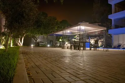 a pavilion with tables and chairs at night at Silver Inn Hotel in Cerro Azul