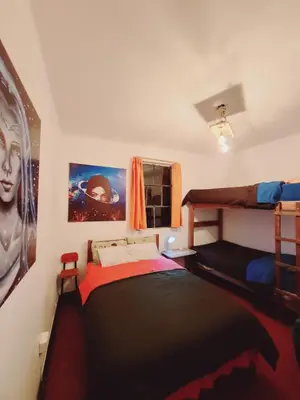 a bedroom with a bed and a bunk bed at Antis Apartment in Cusco