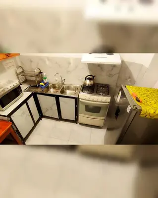 a small kitchen with a stove and a sink at Antis Apartment in Cusco