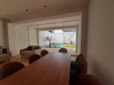 a living room with a wooden table and chairs at Hermosa Casa de Playa km 90.5 in Bujama Baja