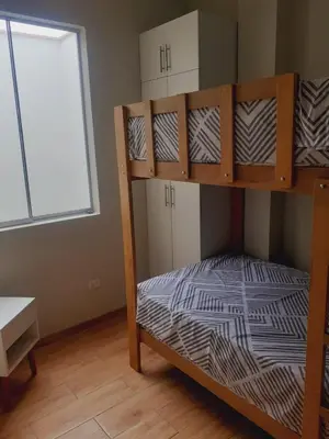a bunk bed in a room with a window at Hermosa Casa de Playa km 90.5 in Bujama Baja