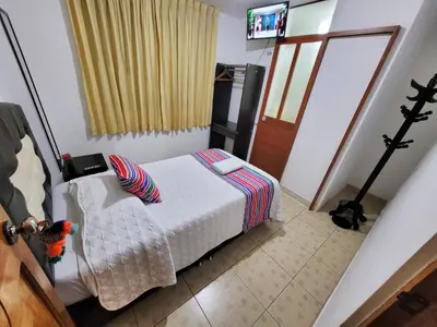a bedroom with a bed and a television in it at Hostal EL VIAJERO en Ollantaytambo in Ollantaytambo