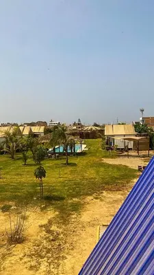 a view of a field with trees and buildings at AMAY in Asia