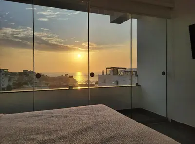 a bedroom with a bed and a view of the sunset at ALTEA HOTEL - San Bartolo in San Bartolo