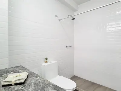 a white bathroom with a toilet and a shower at ALTEA HOTEL - San Bartolo in San Bartolo