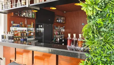 a bar with bottles of alcohol on a counter at ALTEA HOTEL - San Bartolo in San Bartolo