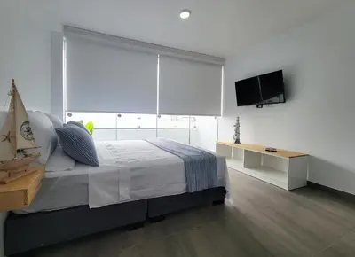 a bedroom with a large window with a bed and a television at ALTEA HOTEL - San Bartolo in San Bartolo