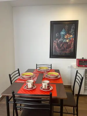 a dining room table with plates and cups on it at (21) Depto. nuevo y acogedor en Miraflores in Lima