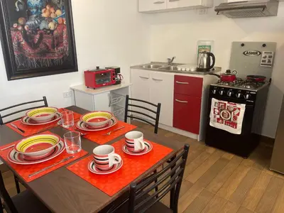 a kitchen with a table with plates and cups on it at (21) Depto. nuevo y acogedor en Miraflores in Lima