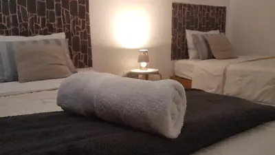 a white towel sitting on top of a bed at Pacific Spot San Miguel in Lima