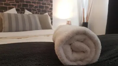 a white towel on top of a bed at Pacific Spot San Miguel in Lima