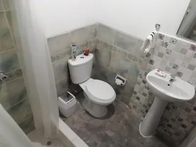 a bathroom with a toilet and a sink at Pacific Spot San Miguel in Lima
