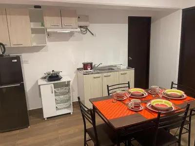 a kitchen with a table with plates and dishes on it at 23 Dpto de Estreno Miraflores in Lima