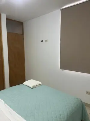 a room with a bed and a projection screen at MH Apartments Ica 2 in Ica