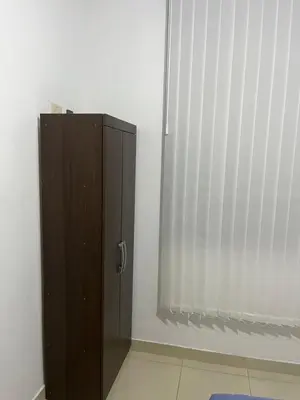 a brown cabinet in a room with a window at MH Apartments Ica 2 in Ica