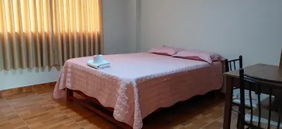 a bedroom with a bed with a candle on it at Catalina Huanca Resort in San Jerónimo