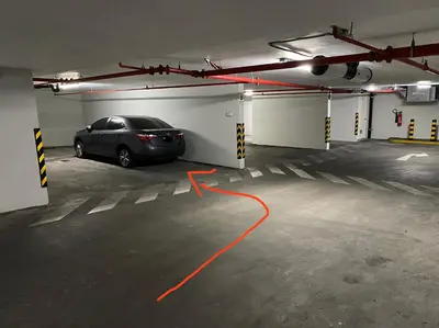 a car parked in a parking garage with an orange hose at Hermoso apartamento con piscina Miraflores- Canvas in Lima