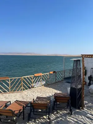 a group of chairs and tables on top of a boat at Atenas Hotel Boutique in Paracas