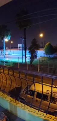 a car driving down a city street at night at Mochileros in Lima