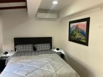 a bedroom with a bed and a picture on the wall at (28) Acogedor dpto. Miraflores in Lima