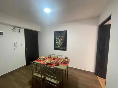 a room with a table with plates of food on it at (28) Acogedor dpto. Miraflores in Lima