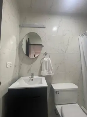 a bathroom with a sink and a toilet and a mirror at (28) Acogedor dpto. Miraflores in Lima