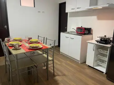 a kitchen with a table with yellow dishes on it at (28) Acogedor dpto. Miraflores in Lima