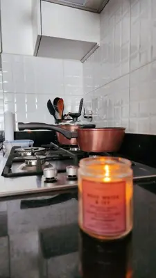 a kitchen with a stove with two pans on it at Depa acogedor en el corazón de la ciudad in Lima