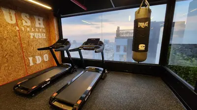 a gym with two exercise bikes and a window at Depa acogedor en el corazón de la ciudad in Lima