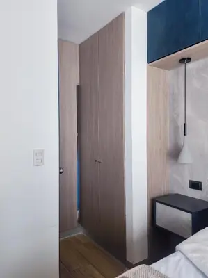 a bedroom with a bed and a wooden cabinet at Depa acogedor en el corazón de la ciudad in Lima