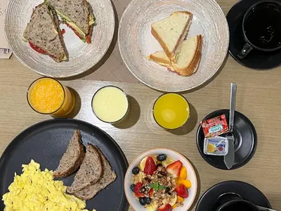 a table with four plates of breakfast food on it at ARTE HOTEL Lima in Lima