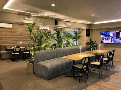 a restaurant with tables and chairs and a couch at ARTE HOTEL Lima in Lima