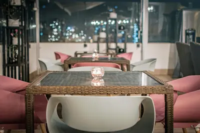 a table and chairs in a room with pink tables and chairs at Hotel Andesmar in Lima