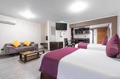 a hotel room with two beds and a couch at Hotel Andesmar in Lima