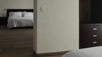 a bedroom with a bed and a dresser with a television at LIMA HOST in Lima