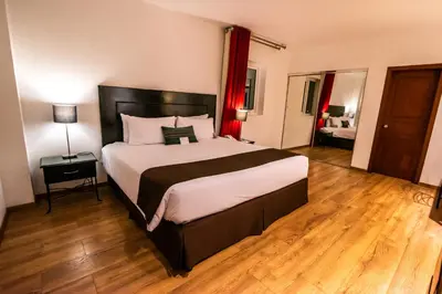 a bedroom with a large bed in a room at El Polo Hotel & Suites in Lima