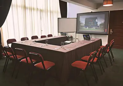a conference room with a long table and chairs at El Polo Hotel & Suites in Lima