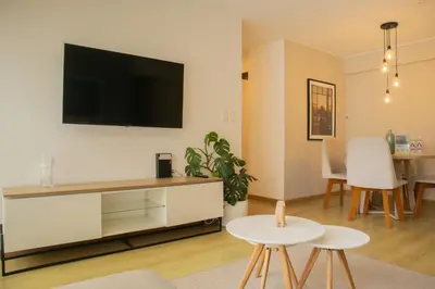 a living room with a flat screen tv on a wall at Cantuarias 355 by Wynwood House in Lima