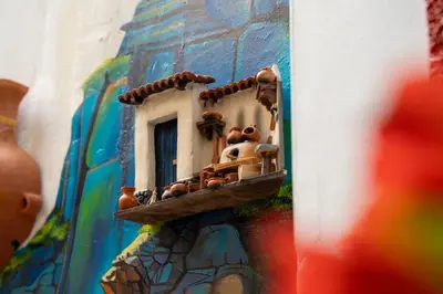 a building with a shelf with pots on it at Casa Antade Cusco in Cusco