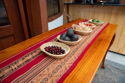 a table with baskets of fruits and vegetables on it at Casa Antade Cusco in Cusco
