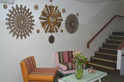 a living room with a couch and mirrors on the wall at Collacocha B&B in Lima