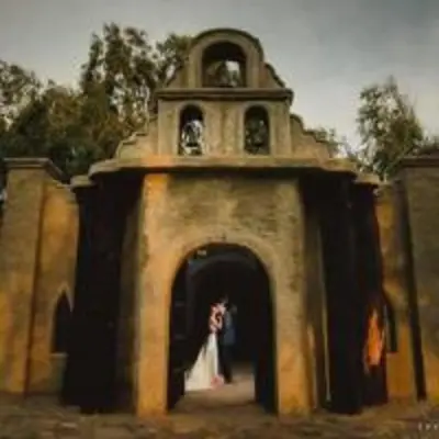 a bride and groom standing in the doorway of a church at Darenas Hacienda in Aucallama