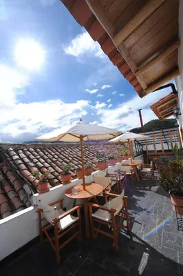a patio with tables and umbrellas on a roof at Casa San Blas Cusco Boutique Hotel in Cusco
