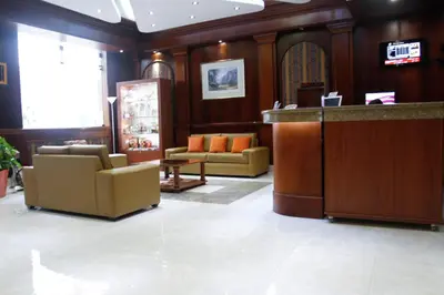 a lobby with two chairs and a reception desk at Hotel Las Palmas in Lima