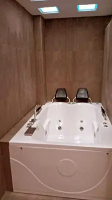 a bath tub with two chairs sitting on top of it at CASITA PARA FIN DE SEMANA in Rancho Cesar